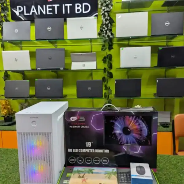 High-quality laptops and gaming monitors displayed on a vibrant green wall at Planet IT BD store, showcasing a wide selection of technology products for consumers.